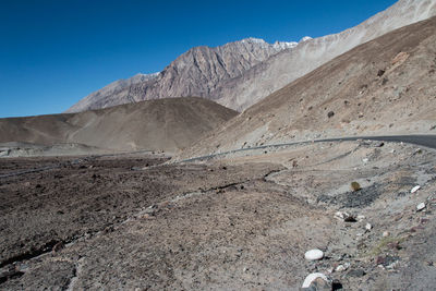 Scenic view of desert against blue sky