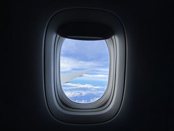 Cloudy sky seen through airplane window