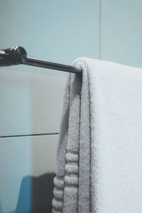 Close-up of clothes drying on rope against wall