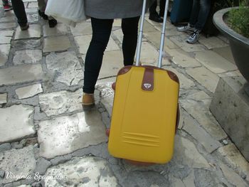 Low section of woman standing on tiled floor