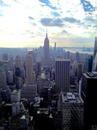 Aerial view of buildings in city against sky