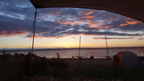 Scenic view of beach against sky during sunset