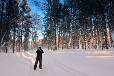 People walking on snow covered landscape