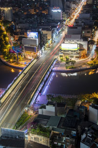 High angle view of illuminated city street and buildings at night