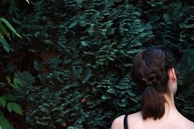 Rear view of woman against plants