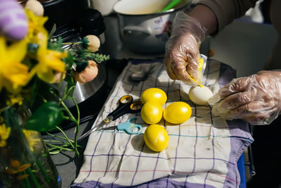 Cropped hand of woman holding food on table