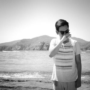 Man standing on shore at beach