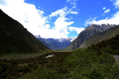 Scenic view of mountains against blue sky