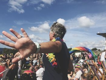 People enjoying at music concert against sky