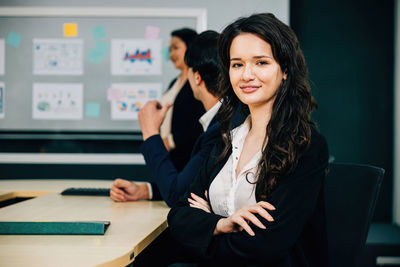 Portrait of young businesswoman standing in office