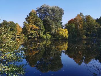 Reflection of trees in lake against sky during autumn