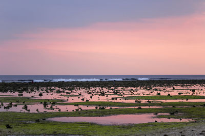 Scenic view of sea against sky at sunset