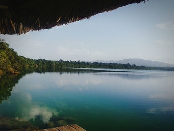 Scenic view of calm lake against sky