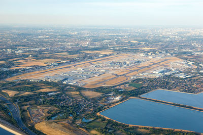 Aerial view of river amidst buildings against sky