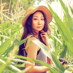 Portrait of beautiful young woman on field