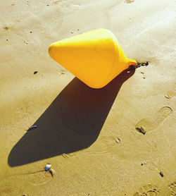 High angle view of yellow leaf on beach