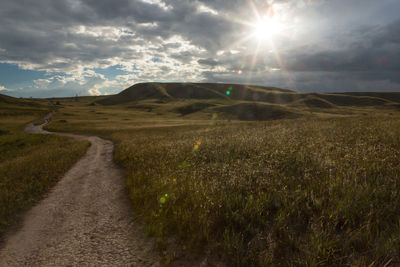 Scenic view of landscape against bright sun