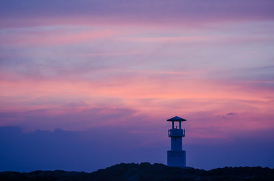 Silhouette lighthouse against sky during sunset