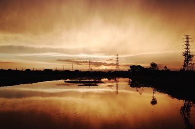 Scenic view of lake against sky during sunset