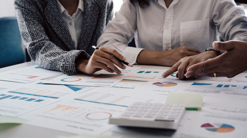 Midsection of business colleagues working at office