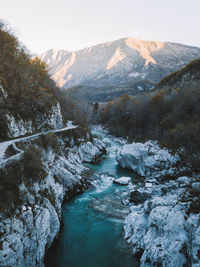Scenic view of river amidst snowcapped mountains against sky