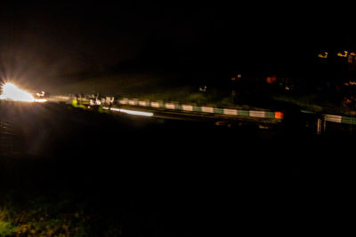 Light trails on road in city at night