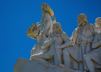 Low angle view of statue against blue sky