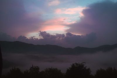 Scenic view of silhouette mountains against sky at sunset