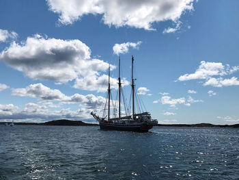 Sailboat sailing on sea against sky