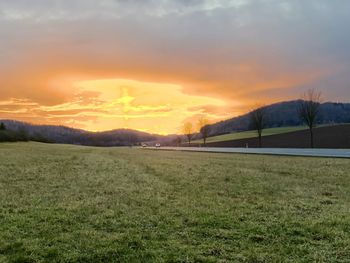 Scenic view of field against sky during sunset