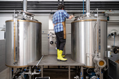 Rear view of man working in factory