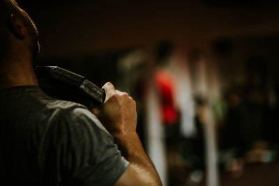 Midsection of man exercising at gym