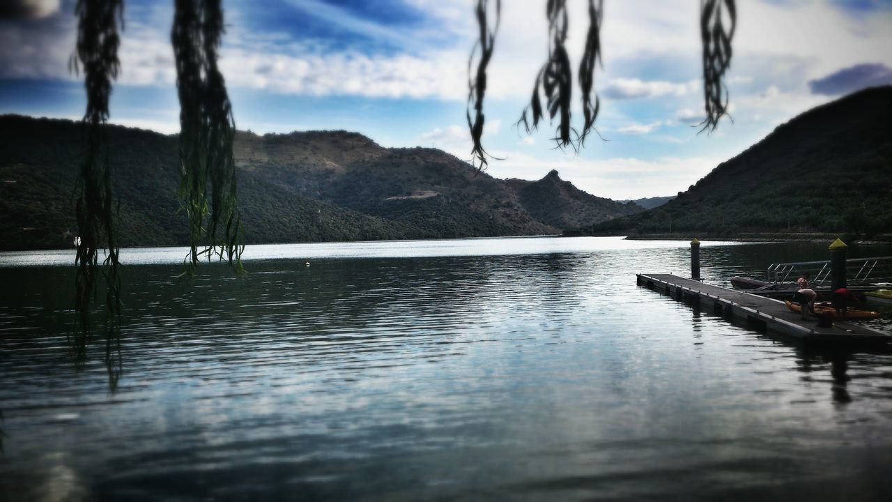 mountain, water, mountain range, lake, sky, tranquil scene, tranquility, scenics, cloud - sky, beauty in nature, nautical vessel, nature, reflection, boat, cloud, non-urban scene, cloudy, waterfront, idyllic, transportation