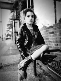 Portrait of young woman sitting outdoors