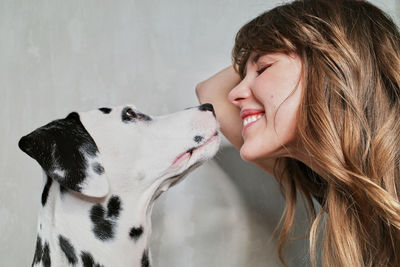 Side view of woman with dog on floor at home