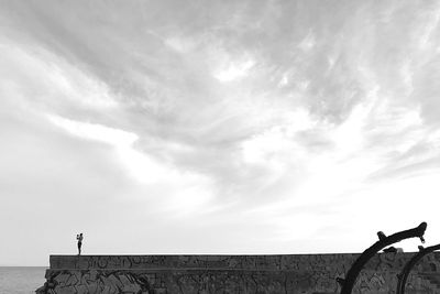 Low angle view of man standing against sky