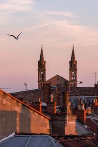 View of buildings against sky at sunset