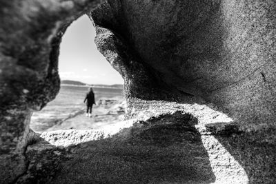 Rear view of woman walking on rock