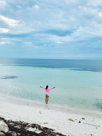 Full length of woman on beach against sky