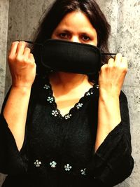 Portrait of woman standing covered with face