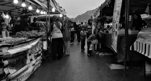 People at market stall in city