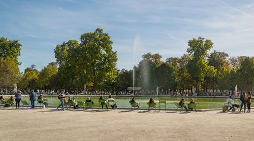 Group of people in park against sky