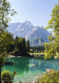 Scenic view of lake and mountains against clear sky