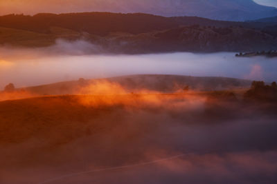 Scenic view of mountains against sky during sunset