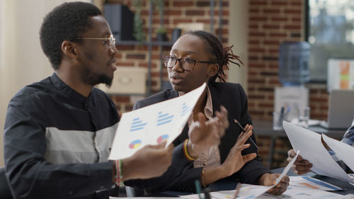 Side view of business colleagues working at office