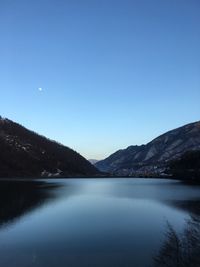 Scenic view of lake against clear blue sky