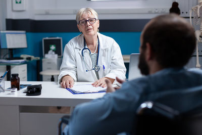 Female doctor examining patient at clinic