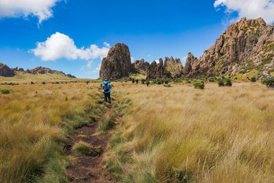 Rear view of a hiker against a mountain at the la satima dragons teeth in the aberdares, kenya