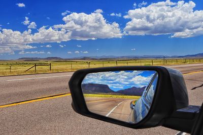 Reflection of sky on side-view mirror