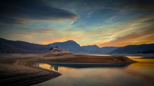 Scenic view of lake against sky during sunset